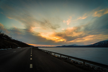 Road in Abisko National Park and Torneträsk Lake at sunset / Lapland, Sweden