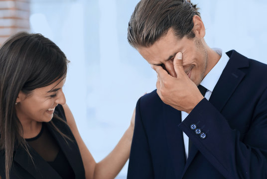 Young Businessman With Tears Of Joy And His Business Team