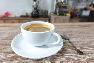 Hot coffee and on wood table.