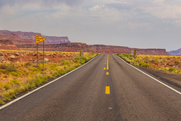 A highway runs along the red-sandstone.