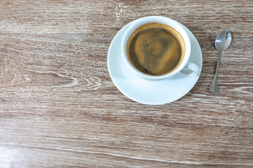 Hot coffee and on wood table.