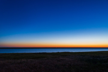 Gradient sunrise sky showing blue, yellow and orange layer