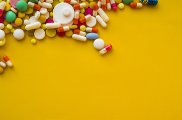 colorful pills on the yellow background