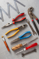 Set of different construction vintage tools and instruments for household on gray concrete background