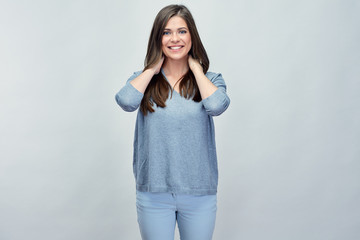 Casual woman with long hair standing in front of gray studio iso