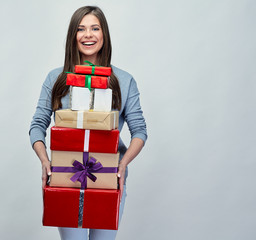 Happy woman holding gift pile, stack.