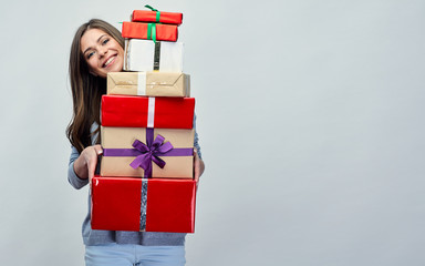 Happy woman holding gift pile, stack.