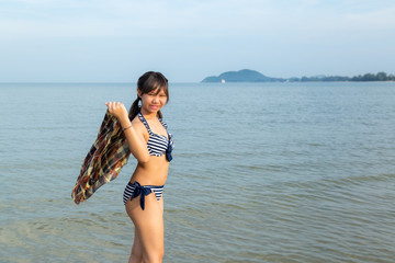 Teenage ware bikini at the beach.