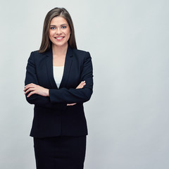 miling business woman wearing black suit standing with crossed a
