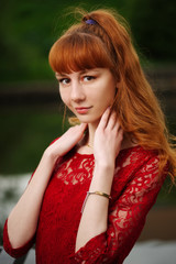 Naklejka premium beautiful red haired girl in park