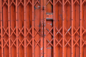 Old red rusty antique slide steel door