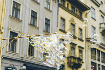 soap bubbles in the center of old european city. having fun