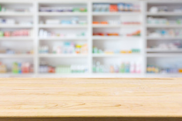 Pharmacy drugstore counter table with blur abstract backbround with medicine and healthcare product on shelves