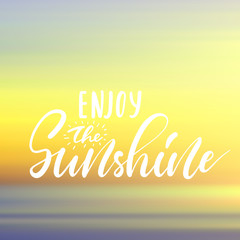 Enjoy the Sunshine - handwritten lettering, summer holiday quote on abstract blur unfocused style sky backdrop