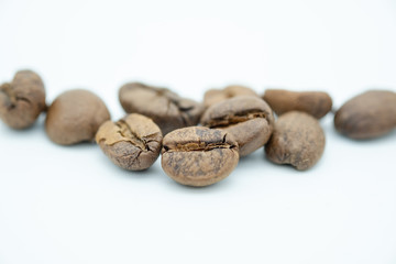 Close up of pile of coffee bean on white background.