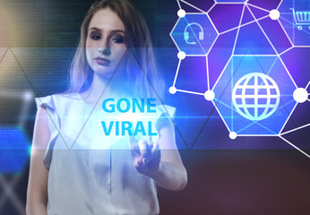 The concept of business, technology, the Internet and the network. A young entrepreneur working on a virtual screen of the future and sees the inscription: Gone viral