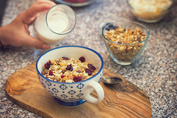 Young women eating healthy breakfast,granola with fresh berry fruits