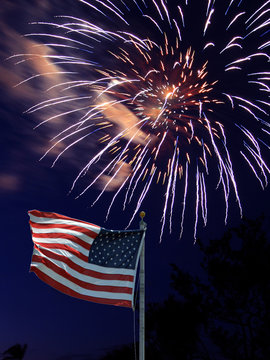 American flag with fireworks behind 16