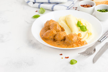 Meatballs with mashed potatoes, creamy tomato sauce, classic delicious food