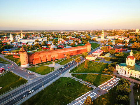 Aerial view of Kolomna, Russia in the evening with a cathedral, Kremlin walls and car traffic