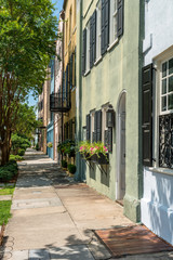 Fototapeta na wymiar Summer Street - A quiet summer morning at one of many quiet, colorful and well-preserved historic streets in Downtown Charleston, South Carolina, USA.