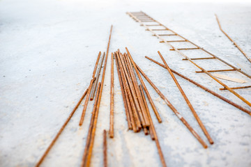 Fototapeta na wymiar Rustic armature lying on the concrete floor on the structure