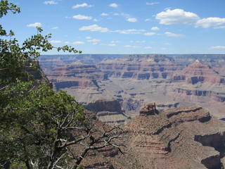 Grand Canyon National Park on a sunny day with blue sky and some clouds, as seen from the South Rim