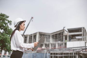 Fototapeta premium Asian women worker and engineer electrician work safety control at power plant energy industry