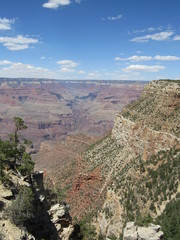 Grand Canyon National Park on a sunny day with blue sky and some clouds, as seen from the South Rim