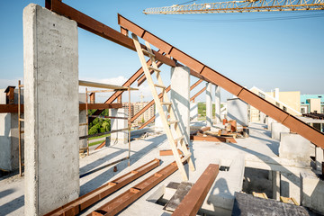 Roof part with metal beams on the construction site during the building process
