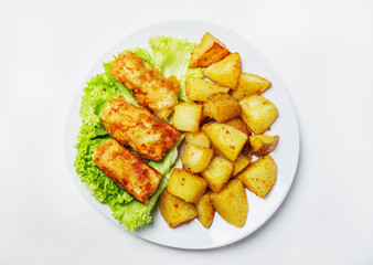 Fish and chips on a plate, white background, top view