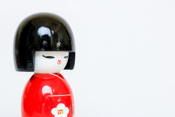 Japanese Wooden Doll Wearing A Red Kimono