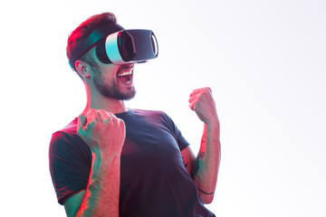 Excited man in VR glasses celebrating win
