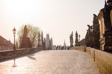 Obraz premium Empty Charles bridge with sculptures in the morning, sunset in Prague, Czech Republic