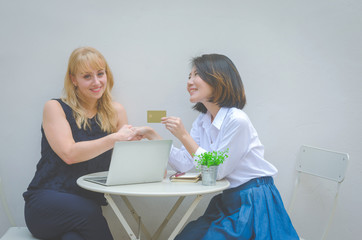 two attractive colleague business woman adviser with working teamwork together discussion planning to complete and successful project direct sale. sale woman present product to customer complete deal.