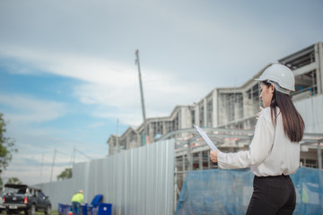 Asian women worker and engineer electrician work safety control at power plant energy industry