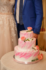 Wedding cake on wedding couple, bride and groom background