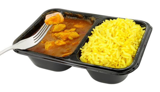 Chicken curry and rice microwave convenience meal isolated on a white background