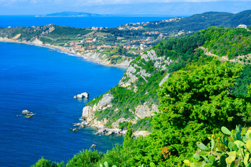 Obraz premium Beautiful summer seascape. Awesome view picturesque green hills coastline sea bay with crystal clear azure water, distant islands in the calm warm sea. Agios Stefanos cape. Afionas. Corfu. Greece.