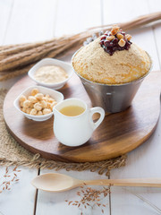 Korean bean Bingsu, sweet milk dessert serve on wood tray and stainless bowl