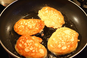 Preparation of pancakes in a frying pan on a gas stove. Pancakes with milk. Close-up.