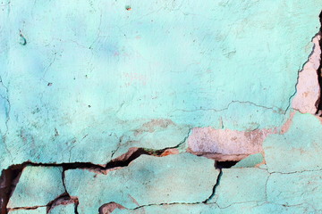 Cracked brick wall covered with cement. Background. Close-up.