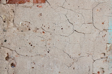 The old wall is covered with cement with cracks. Close-up. Background.