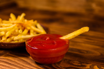 Fresh french fry dipped into the tomato sauce