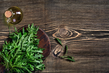 Fresh green arugula on wooden table