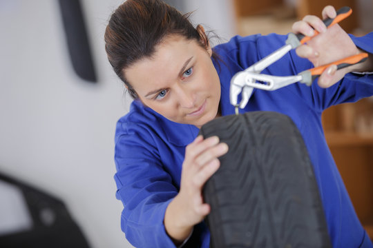 female mechanic changing car tire