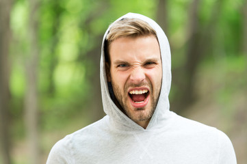 Man with bristle on shouting face, nature background, defocused. Skin care concept. Man with beard...