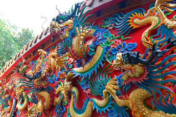 chinese dragon statue at the wall of temple in Thailand