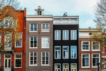 Fototapeta premium Beautiful Architecture Of Dutch Houses On Amsterdam Canal In Autumn