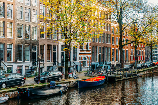 Beautiful Architecture Of Dutch Houses and Houseboats On Amsterdam Canal In Autumn © radub85
